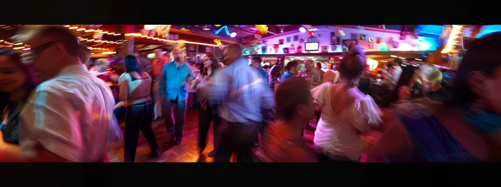 a crowded dance floor with vibrant music and colorful lights in a lively san francisco salsa club.